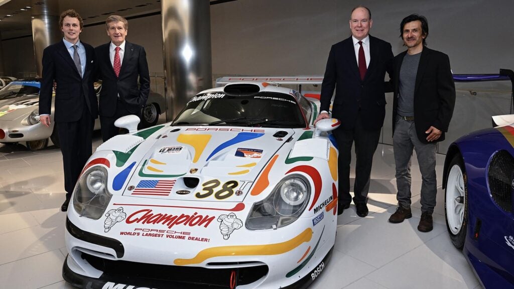 4 men standing next to a White Porsche