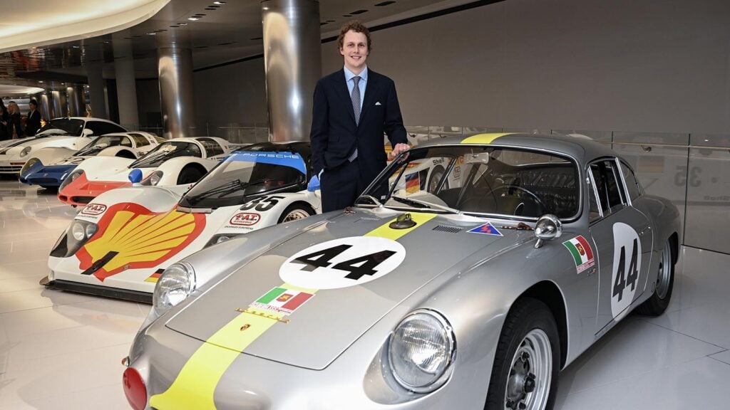 Man standing next to Grey Porsche