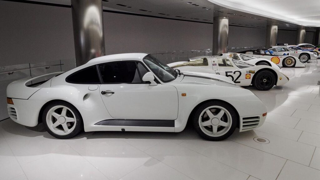 White Porsche 959 with other Porsche's display showroom