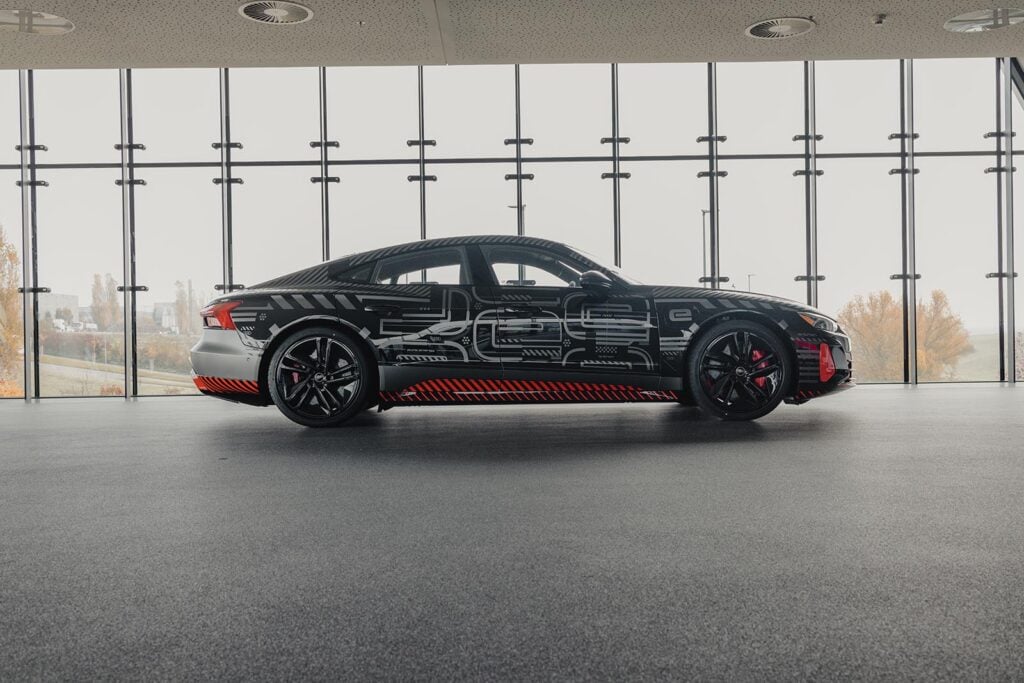 Side profile view black Audi e-tron GT window showroom