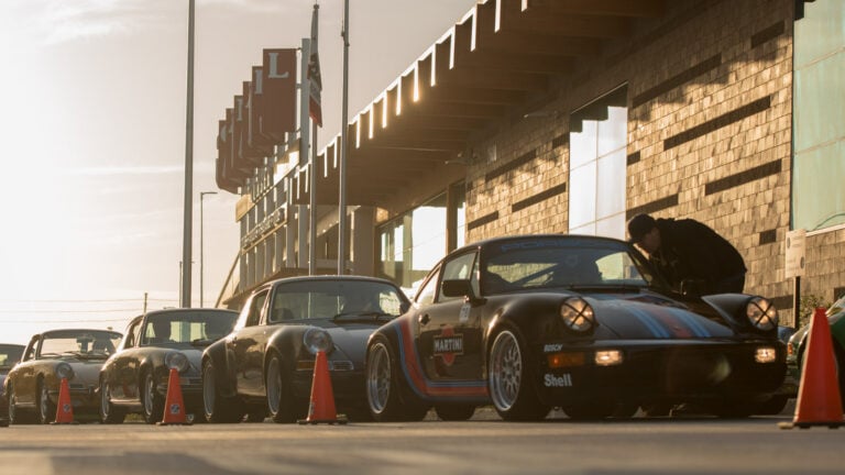 line of Porsche cars on racetrack