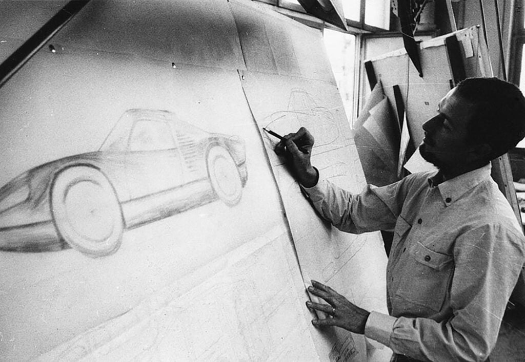 black and white photo of Ferdinand Alexander Porsche drawing car