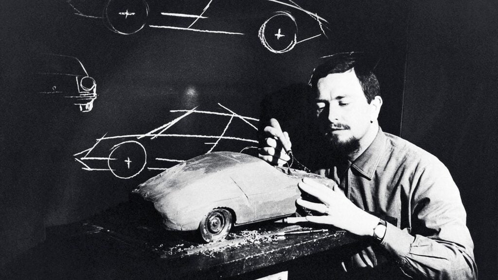 black and white photo man modeling a car