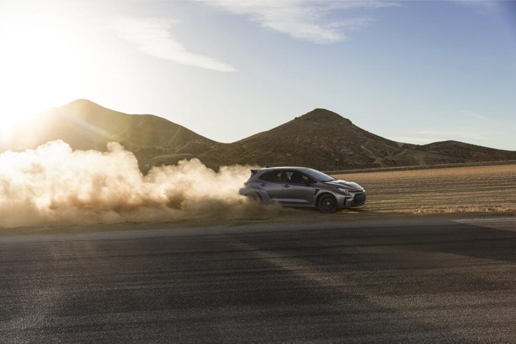 Grey GR Corolla in desert with dust cloud
