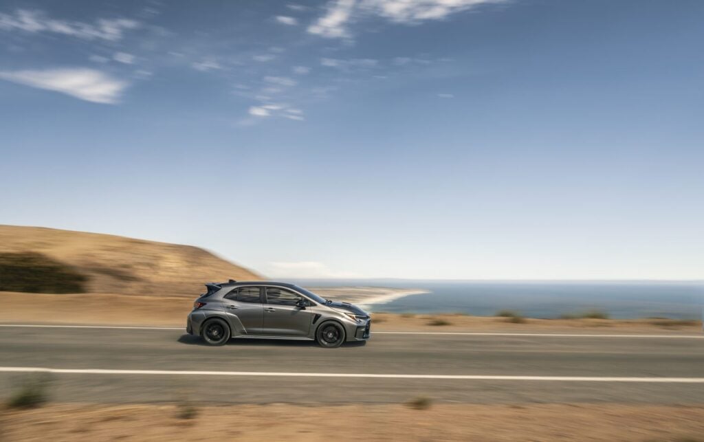GR Corolla driving past ocean