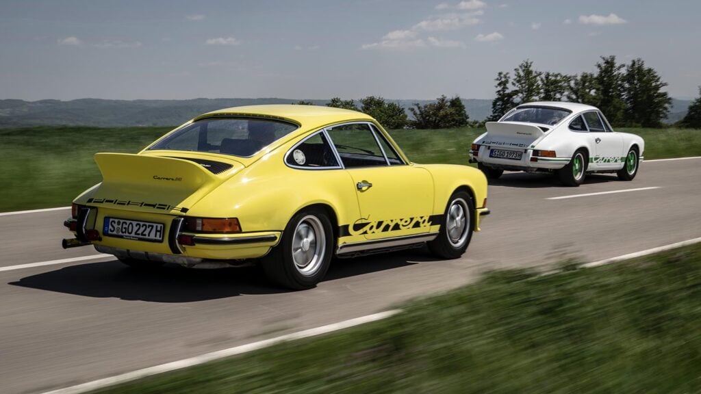 two porsche carrera RS yellow and white racing on road