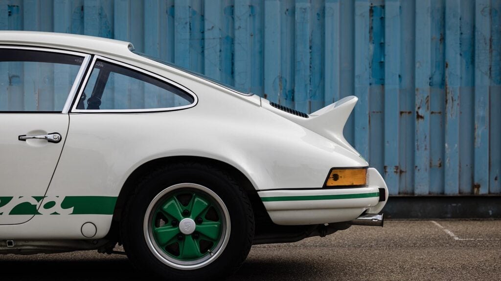 White 3/4 shot Porsche Carrera RS rear wing shipping container background