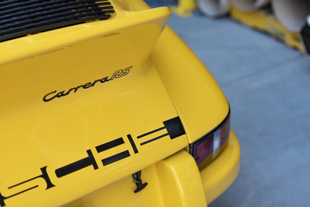 Closeup of yellow Porsche Carrera RS badge