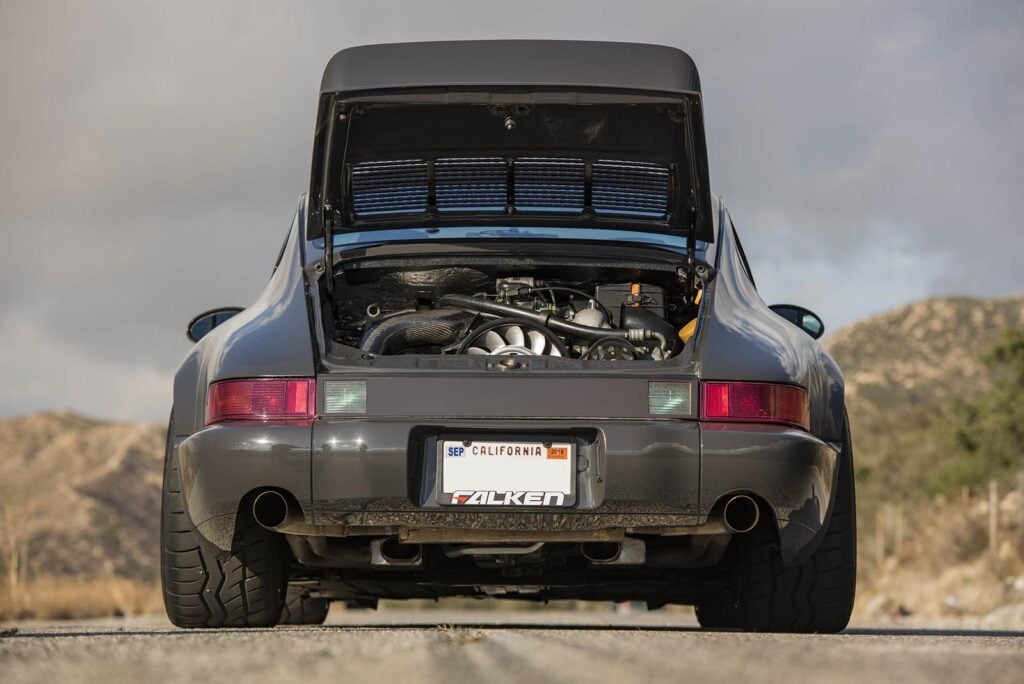 grey Porsche 964 rear hood up on road