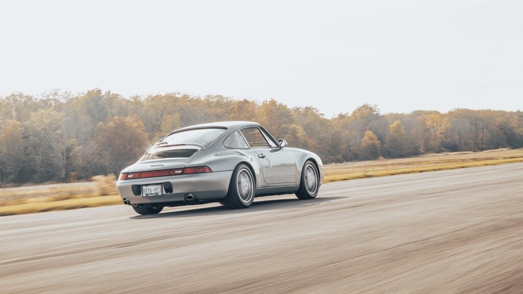 Grey Porsche 993 Turbo racing on track