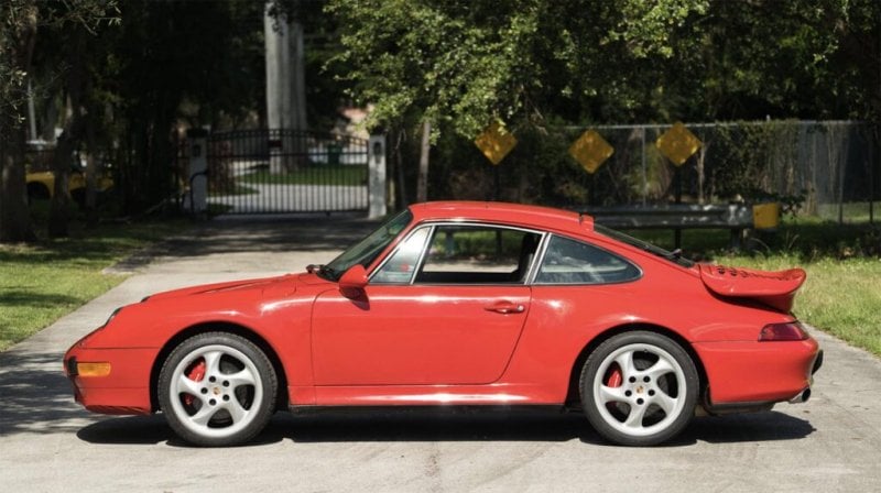 Red 993 side profile parked