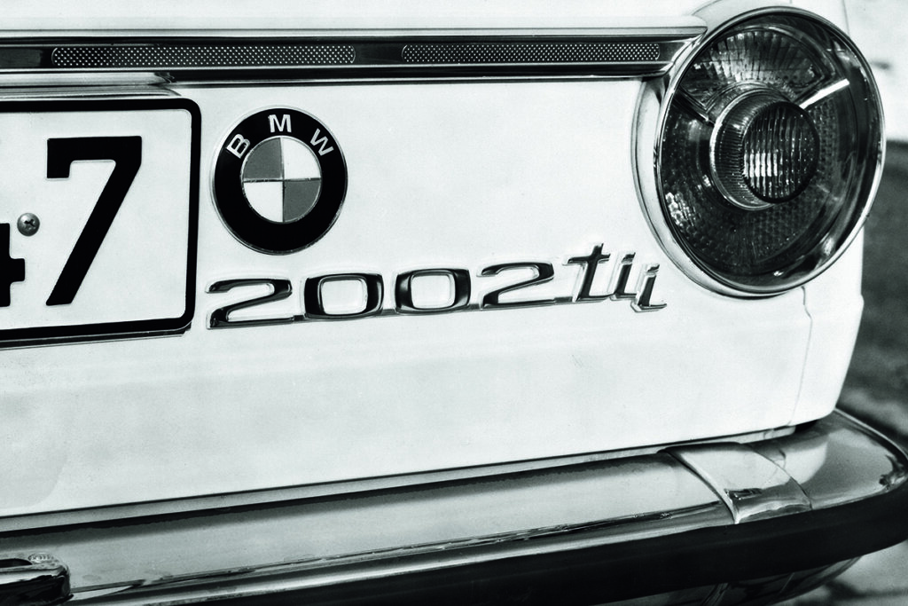 black and white photo of 2002tii BMW badge