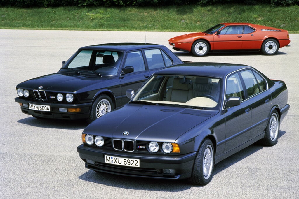 3 BMW cars on asphalt