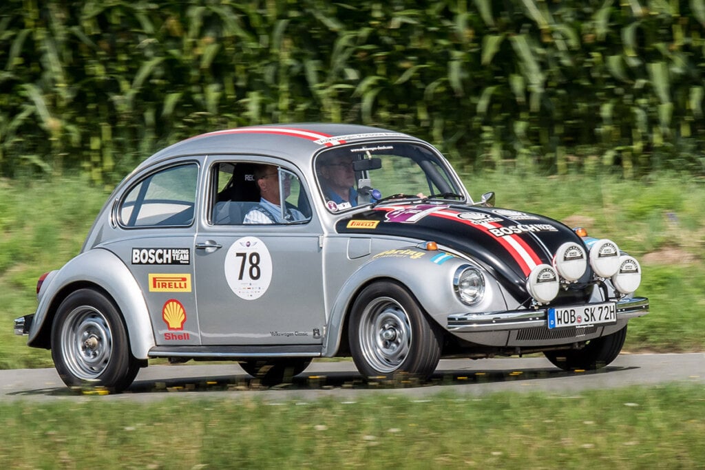 Silver VW bug racing on track