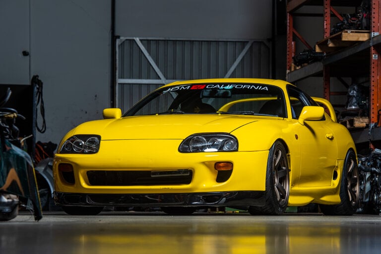 yellow Toyota supra in garage