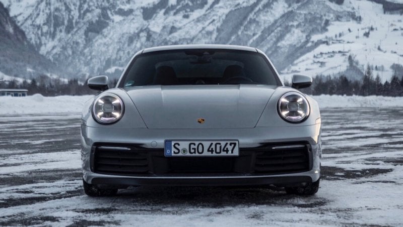 silver Porsche 992 car in snow