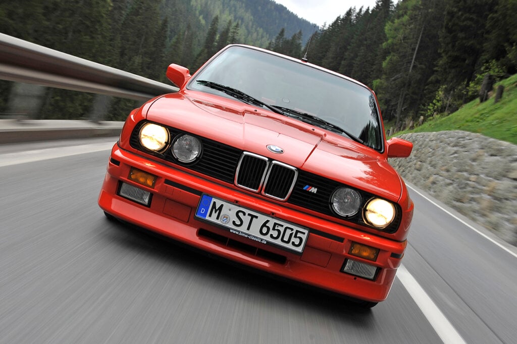 red e30 m3 driving on mountain road
