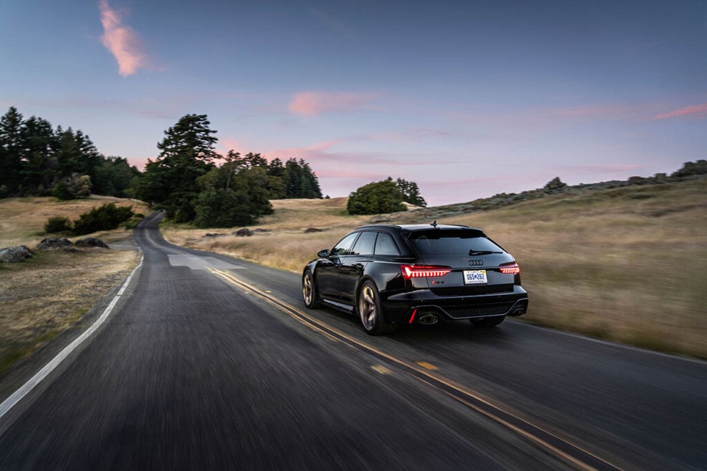 black audi r6 avant speeding through the county roads
