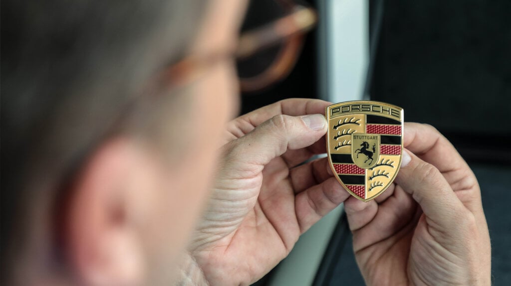 Porsche designer inspecting new Porsche crest
