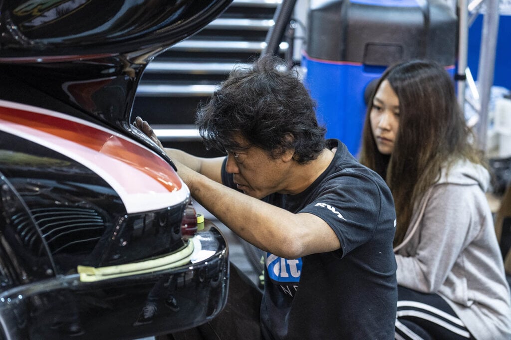 akira nakai and a rwb worker tuning a car