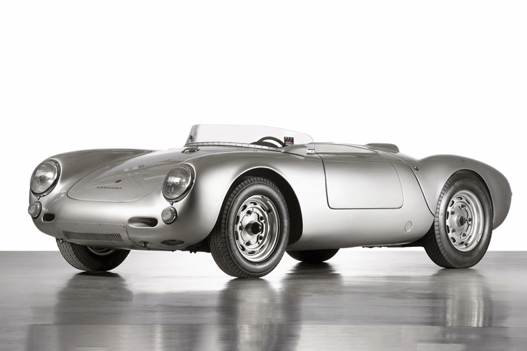 Silver Porsche 550 Spyder on concrete with white background