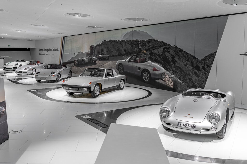 Porsche models 550 Spyder next to others in showroom