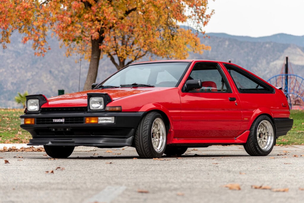 red AE86 parked by park
