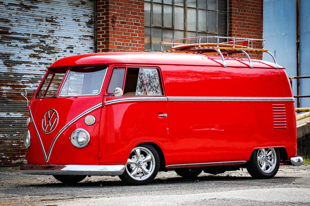 Red Type 1 VW Bus with surfboard on top