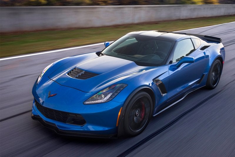 Blue c7 driving on road