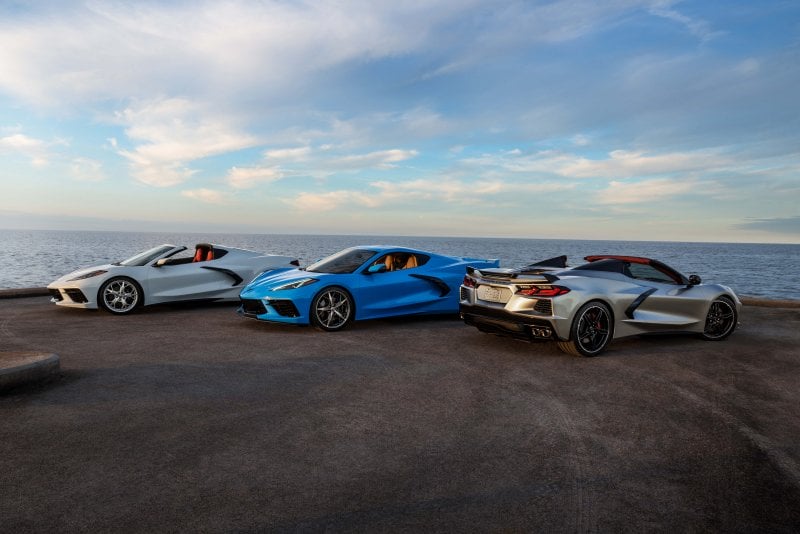 3 of the C8 Corvette's on a cliff overlooking the ocean