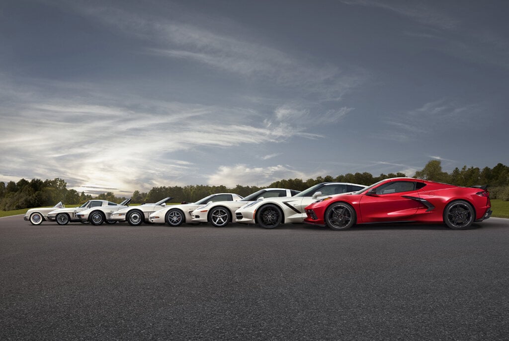 8 vehicles lined up next to each other on racetrack