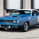 1971 Barracuda two tone blue and white in front of garage doors