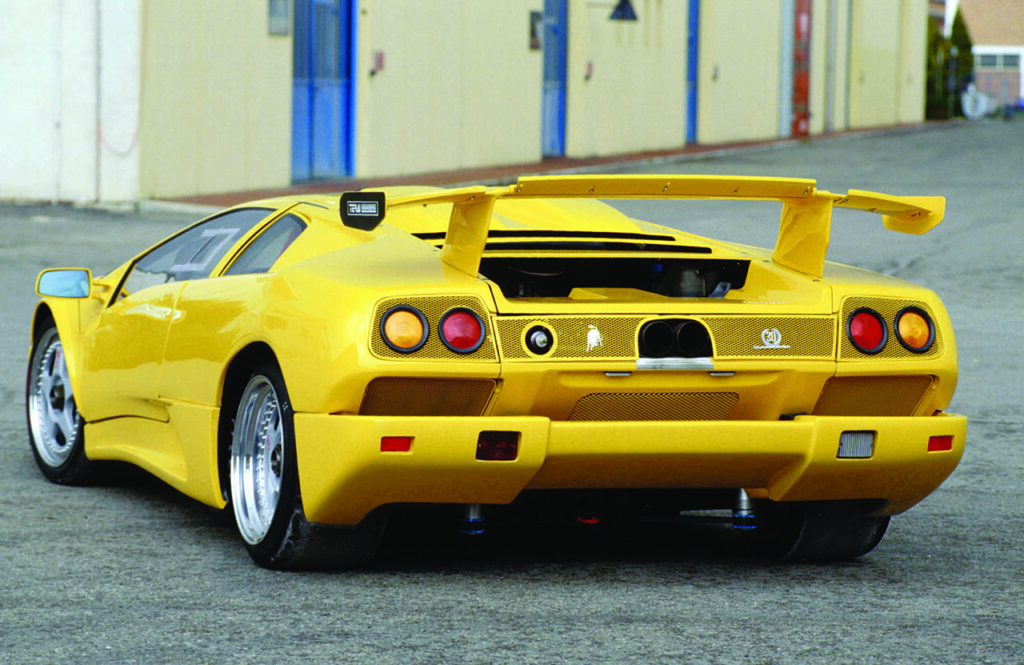 yellow diablo jota model next to storage units