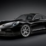 Black Porsche 911 R/T car on black background with chrome wheels and glossy paint