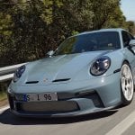 blue Porsche 911 st on road driving aggressively