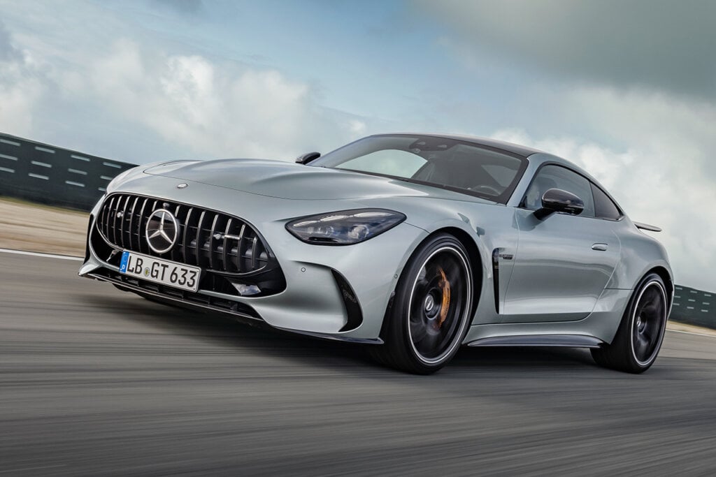 2nd Gen AMG GT Coupe driving fast on road, cloudy sky behind it