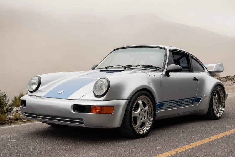 964 Porsche grey and blue on road with smoky background
