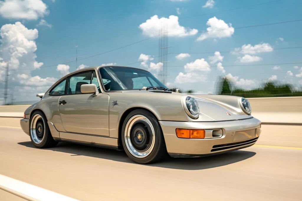 silver 911 on highway with clear sky in background