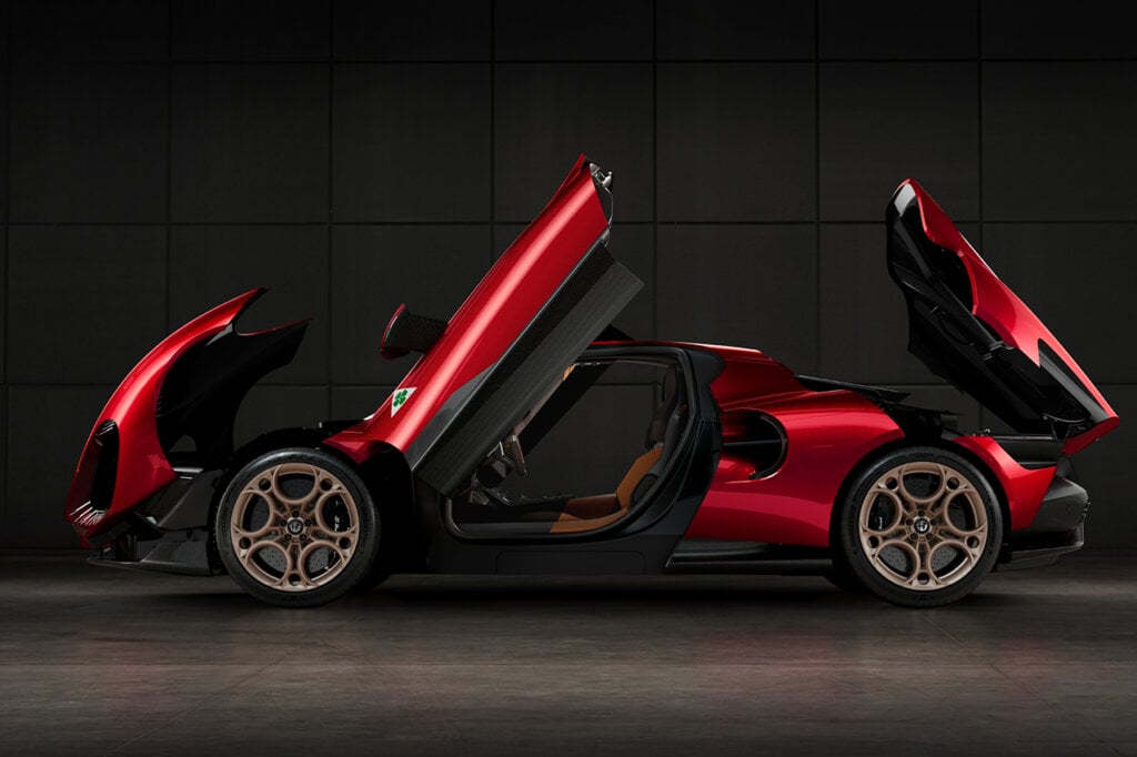 side profile with the Hood, Butterfly doors, Trunk opened up on a red Alfa Romeo. Black background behind the car
