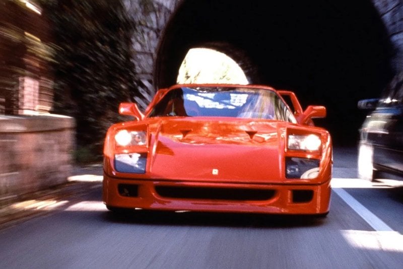 Red F40 driving through a tunnel and passing another car