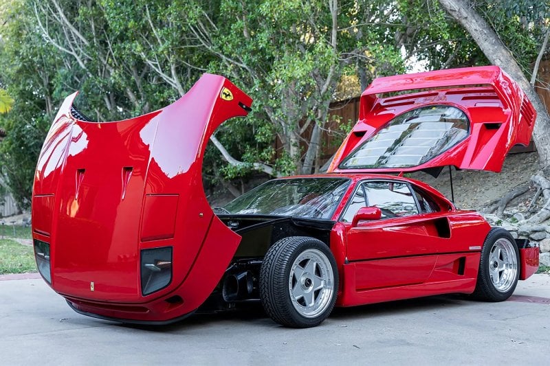 F40 with frunk and rear Engine hood propped open in front of tree branches