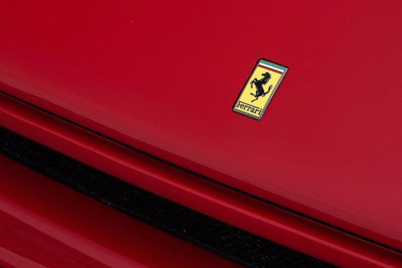 Ferrari badge on a red vehicle