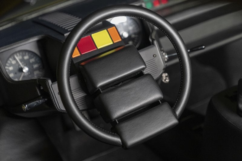Lamborghini Steering wheel all black with 3 pads in the center of it