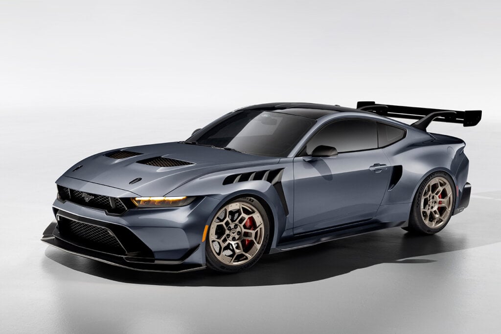 2025 Grey Mustang GTD with a big racing spoiler wing and gold wheels on white background