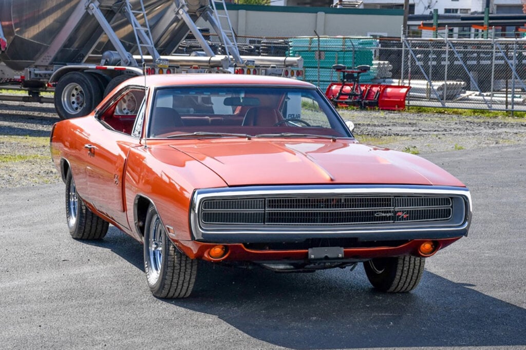 bright orange dodge charger in construction zone