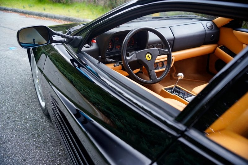 Black Ferrari 512TR with tan leather and black steering wheel and gated manual stick shift