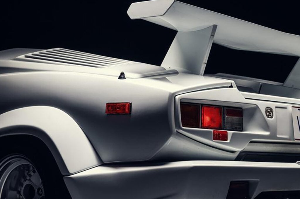 rear side of white Countach car black background