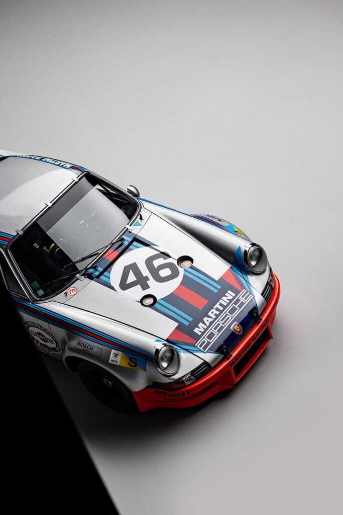 Martini Porsche race car, Blue and red stripes and 46 number on hood, black triangle border in lower left