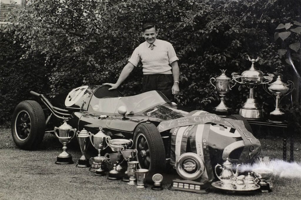 bruce mclaren with racing awards and trophies