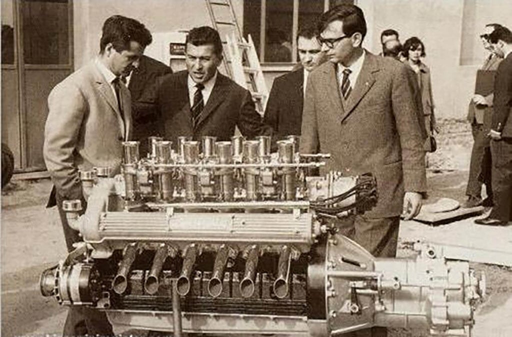 Giotto Bizzarrini, Ferruccio Lamborghini and Giampaolo Dallara at Sant'Agata Bolognese in 1963, with a Lamborghini V12 engine prototype.